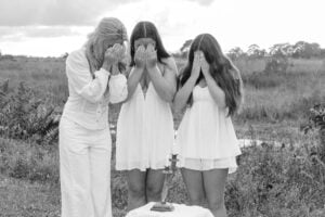 A family lighting Shabbat candles together at home during Neshamah's virtual gathering at niboca.org