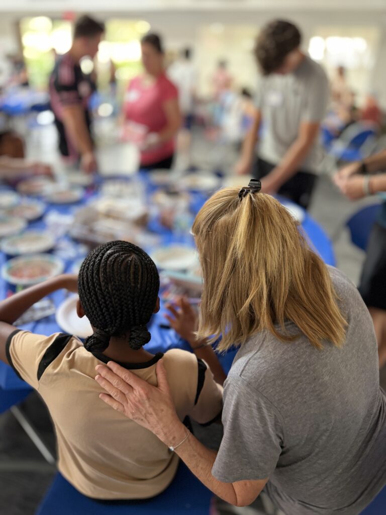 Families making friendship bracelets together at the Neshamah Spring Mitzvah Fair at SOS Children's Village in Coconut Creek, niboca.org