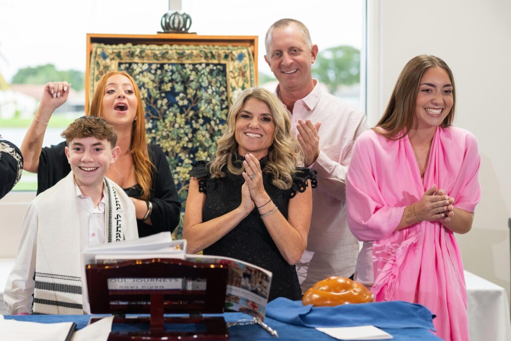 Family celebrating together after their child's Bar or Bat Mitzvah ceremony, Neshamah Institute, niboca.org